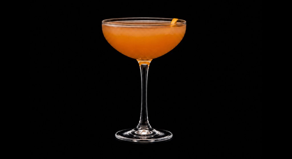 Fly Like a Butterfly cocktail on a dark studio background