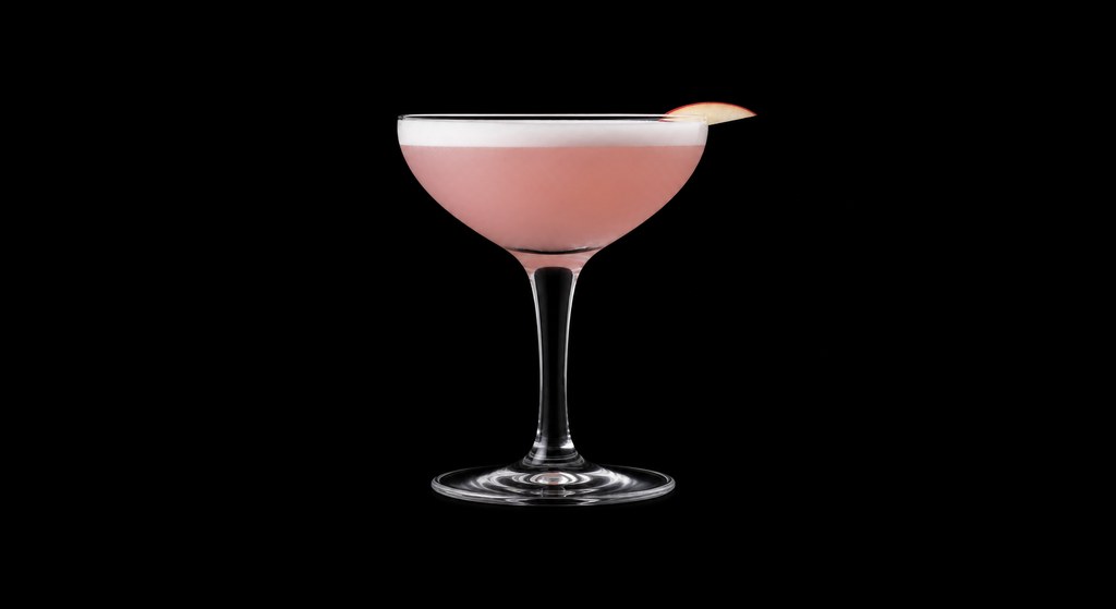 Forbidden Fruit Martini cocktail on a dark studio background