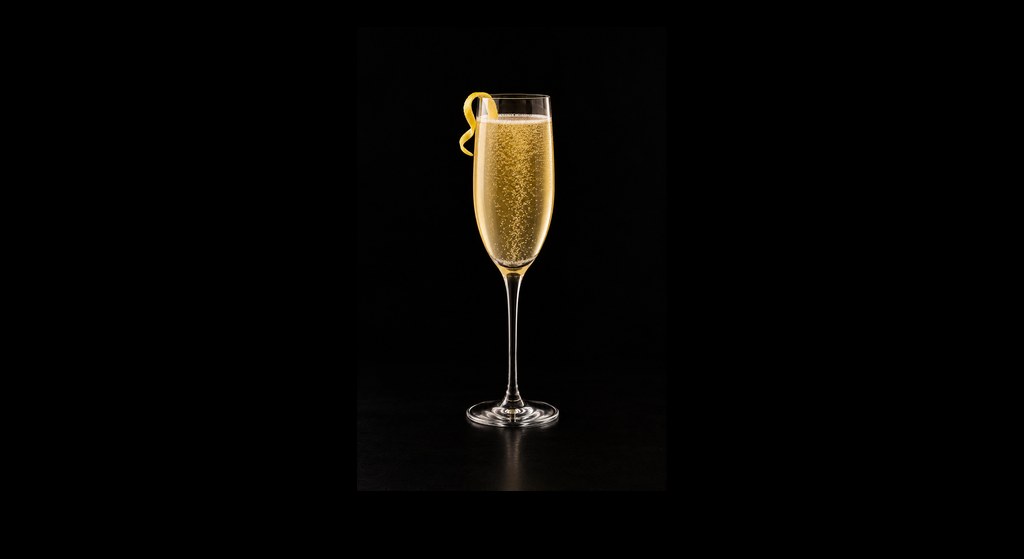 French 125 cocktail on a dark studio background
