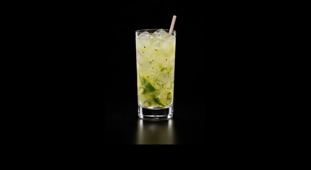 French Kiwi & Apple Caipirinha cocktail on a dark studio background