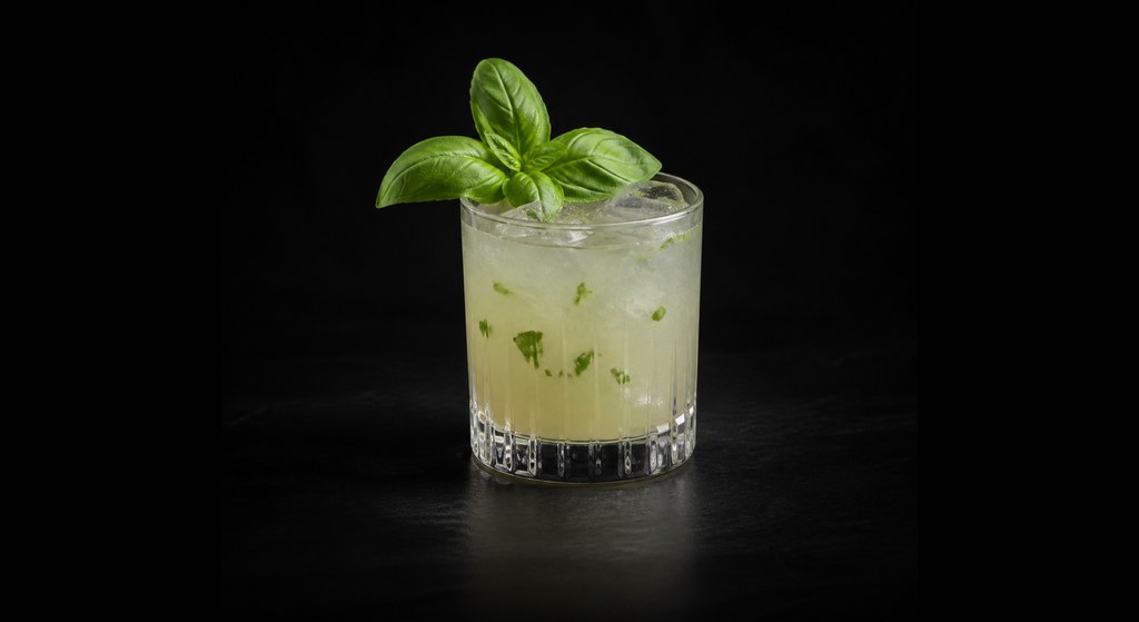 Gin Basil Smash cocktail on a dark studio background