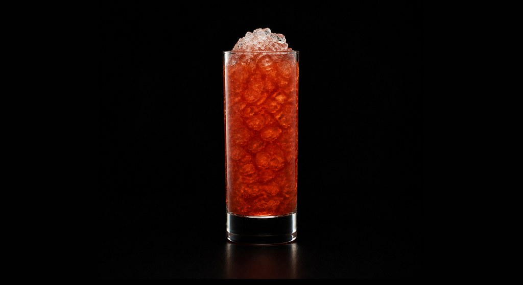 Golden Frappe cocktail on a dark studio background