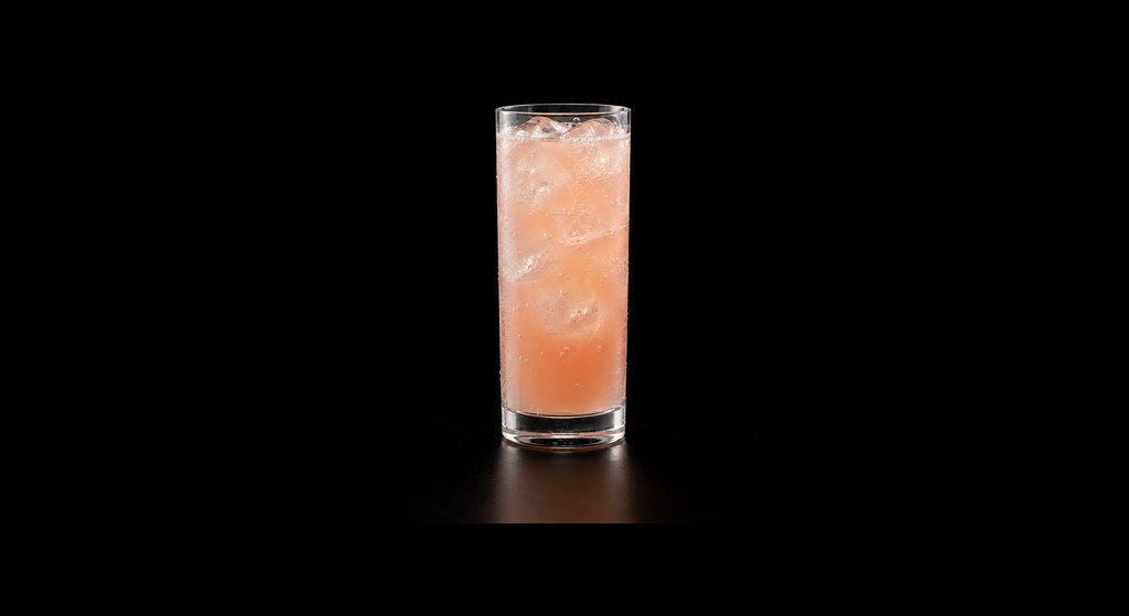 Grapefruit Ginger Fizz cocktail on a dark studio background