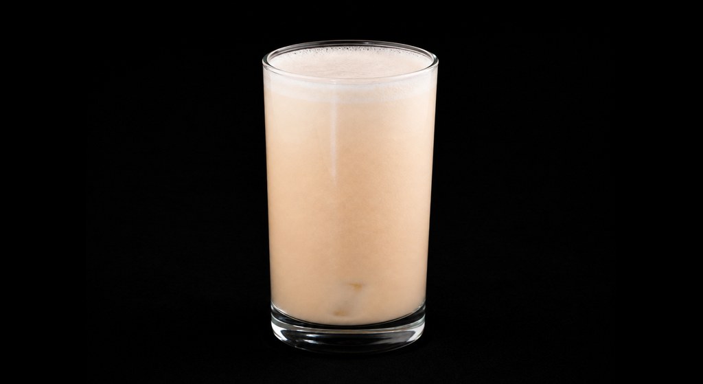Grapefruit Nog cocktail on a dark studio background