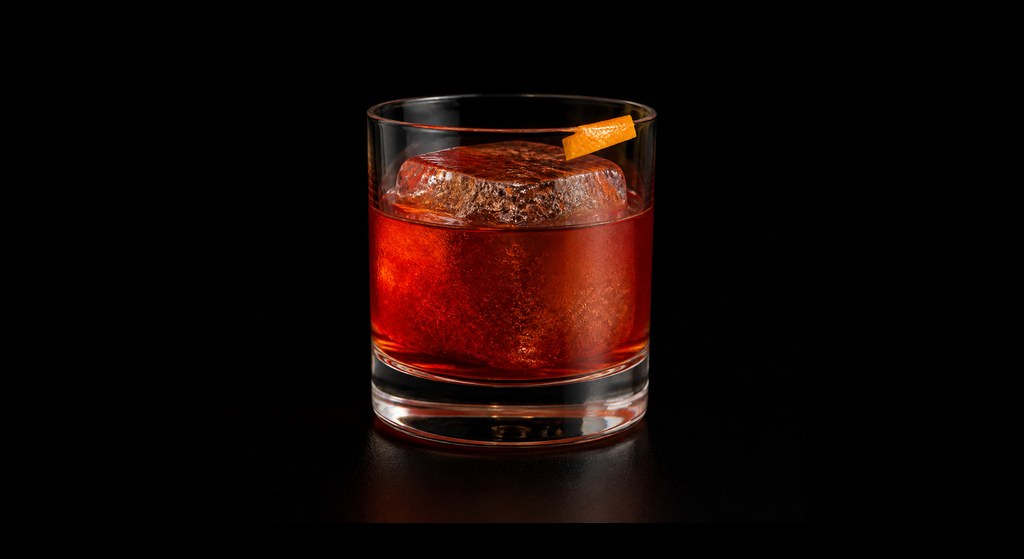 Greek Sheroni cocktail on a dark studio background