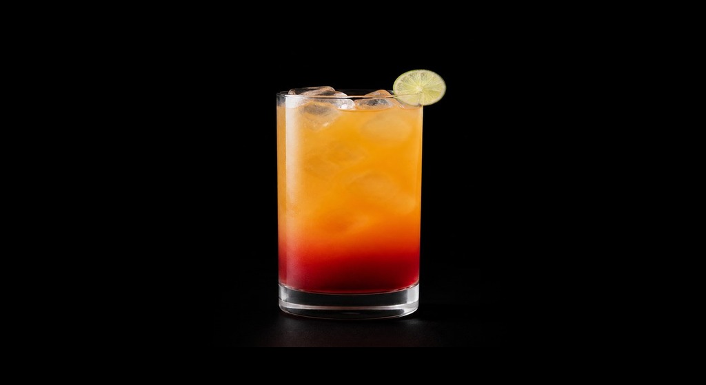 Hairy Sunrise cocktail on a dark studio background