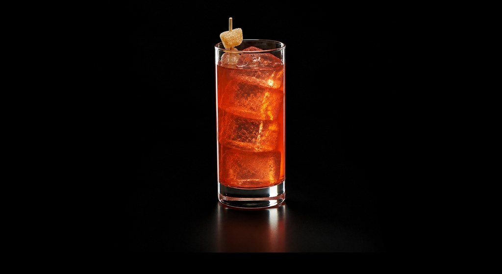 Infernal Collins cocktail on a dark studio background