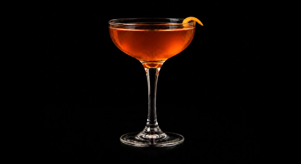 Jack Rose’s Kümmel Trident cocktail on a dark studio background