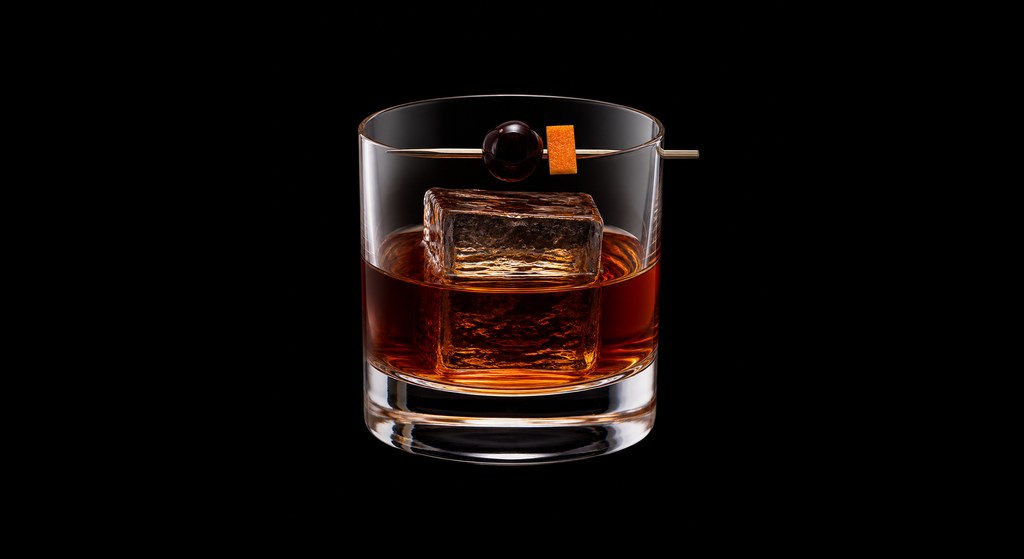 Jäger Old-Fashioned cocktail on a dark studio background