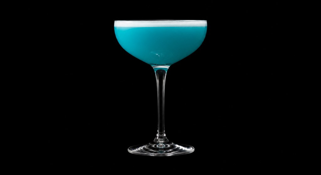 John deBary's Blue Hawaii cocktail on a dark studio background