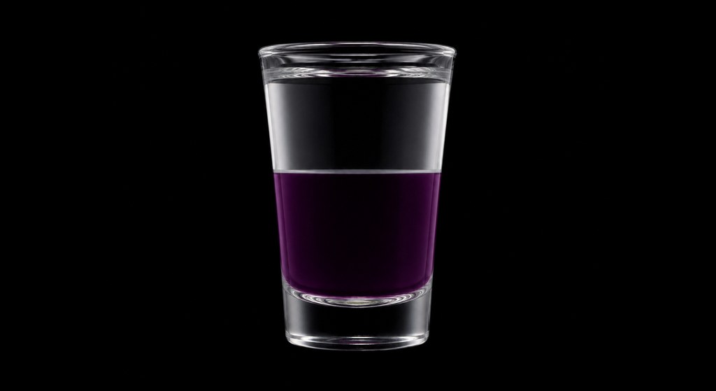 Kool-Aid Slammer cocktail on a dark studio background