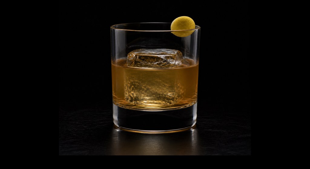 Kotobuki Old-Fashioned cocktail on a dark studio background