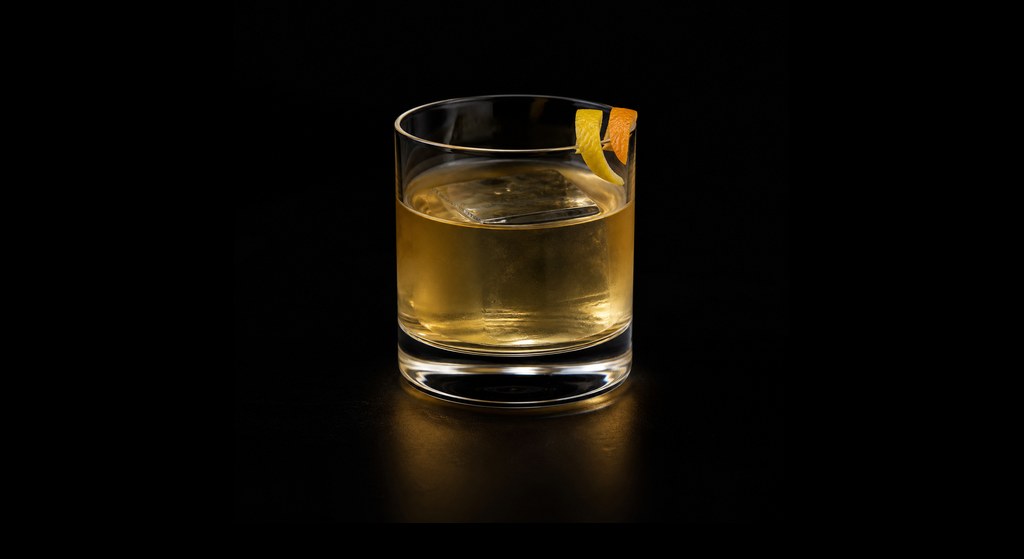Le Sang Jaune (The Yellow Blood) cocktail on a dark studio background