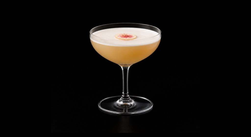 Magie Noire cocktail on a dark studio background