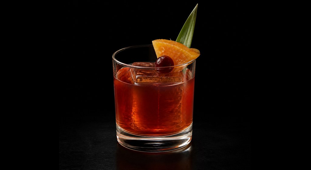 Maison Premiere's Jungle Bird cocktail on a dark studio background