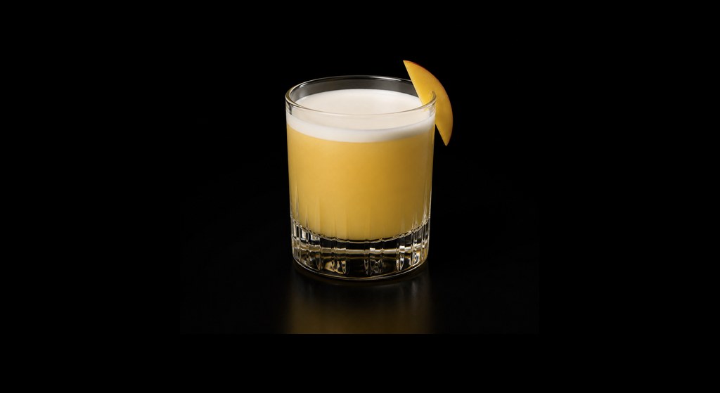 Mandy's Mango Sour cocktail on a dark studio background