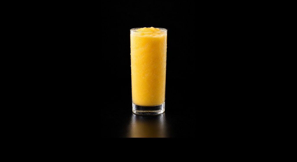 Mango Colada Mocktail cocktail on a dark studio background