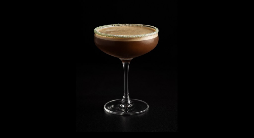 Matcha Mocha Espresso Martini cocktail on a dark studio background