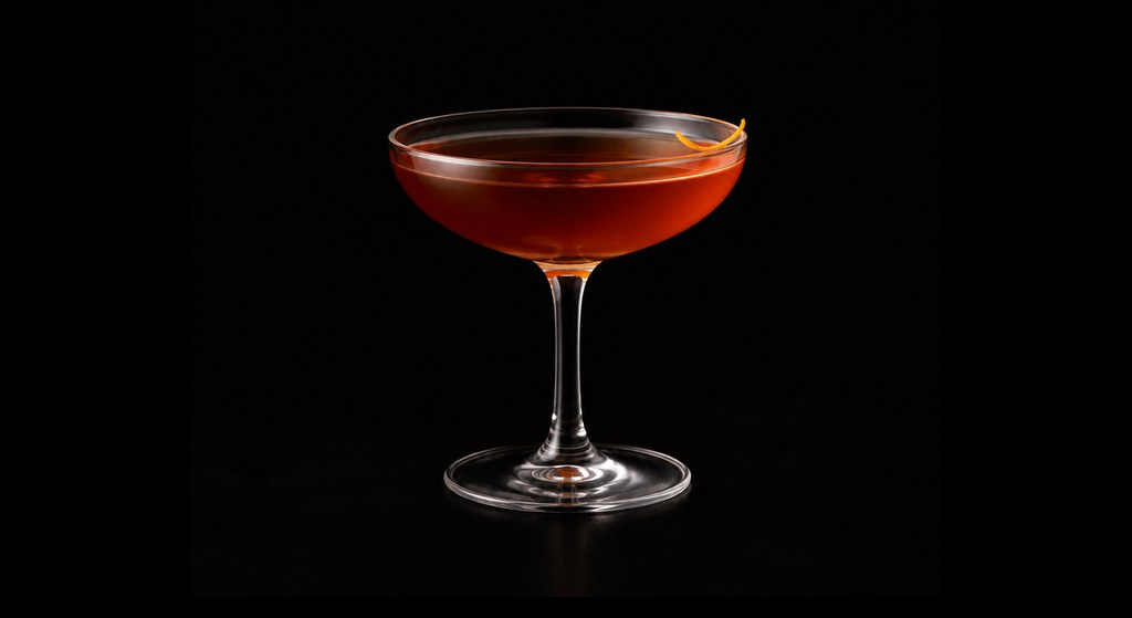 Mezcal Martinez cocktail on a dark studio background