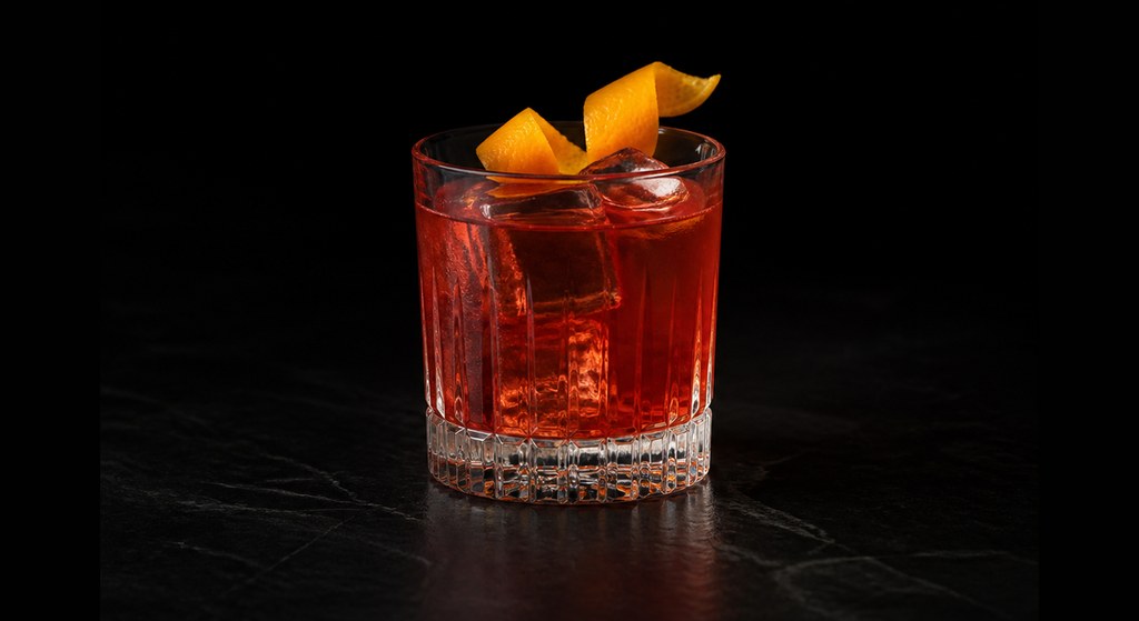 Mezcal Negroni cocktail on a dark studio background