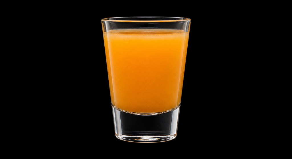 Orange Crush cocktail on a dark studio background
