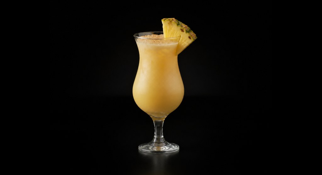 Painkiller cocktail on a dark studio background