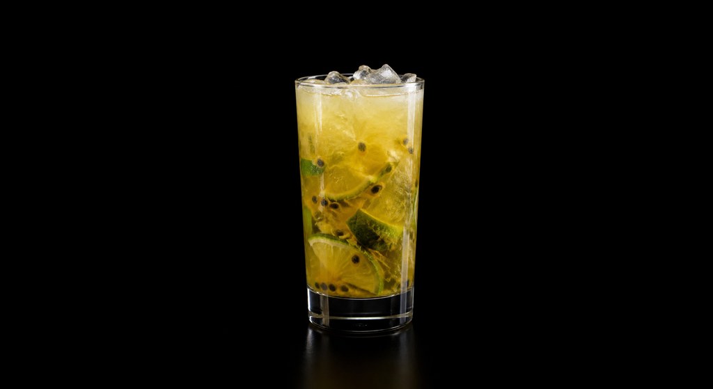 Passion Fruit Caipirinha cocktail on a dark studio background