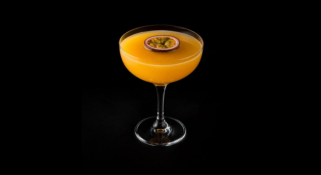 Passion Fruit Margarita cocktail on a dark studio background