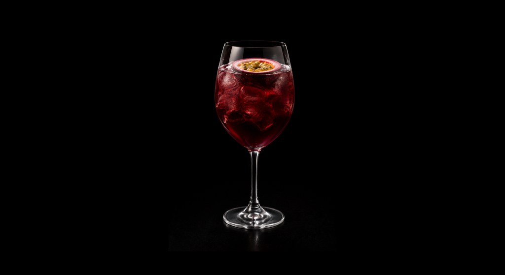 Passion Fruit Sangria cocktail on a dark studio background