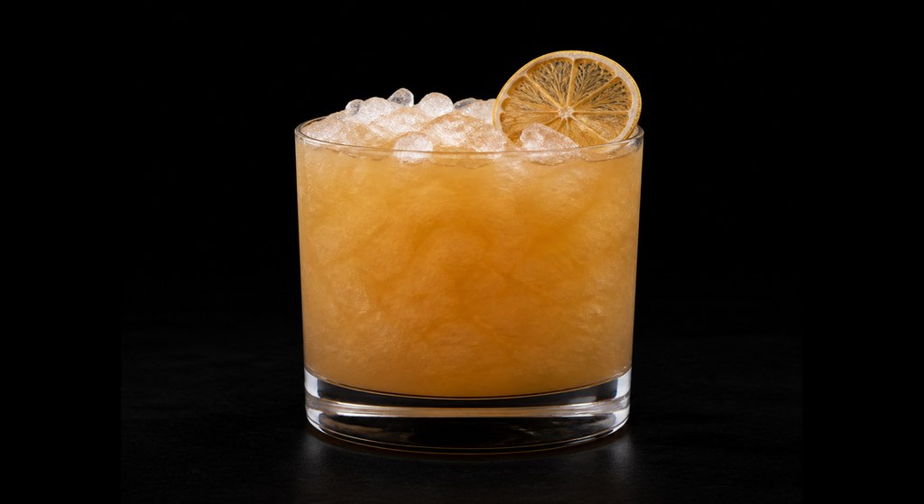Peach Bourbon Smash cocktail on a dark studio background