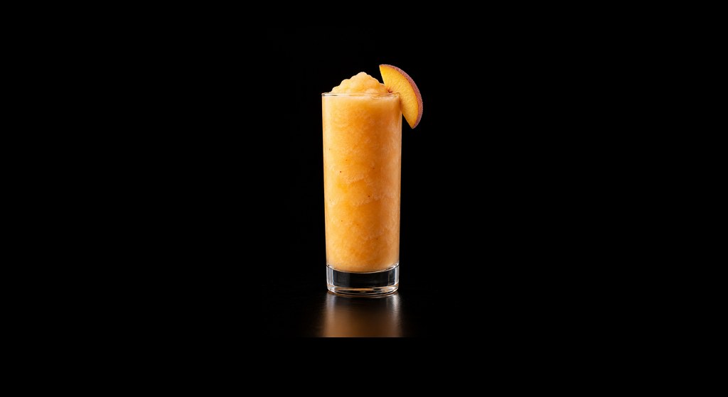 Peaches & Cream cocktail on a dark studio background