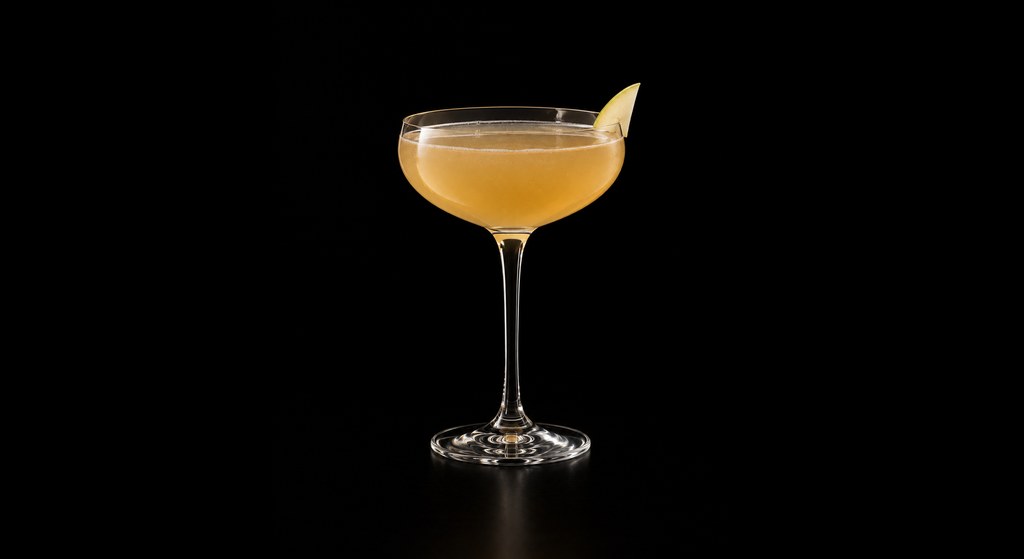 Pear & Cardamom Sidecar cocktail on a dark studio background