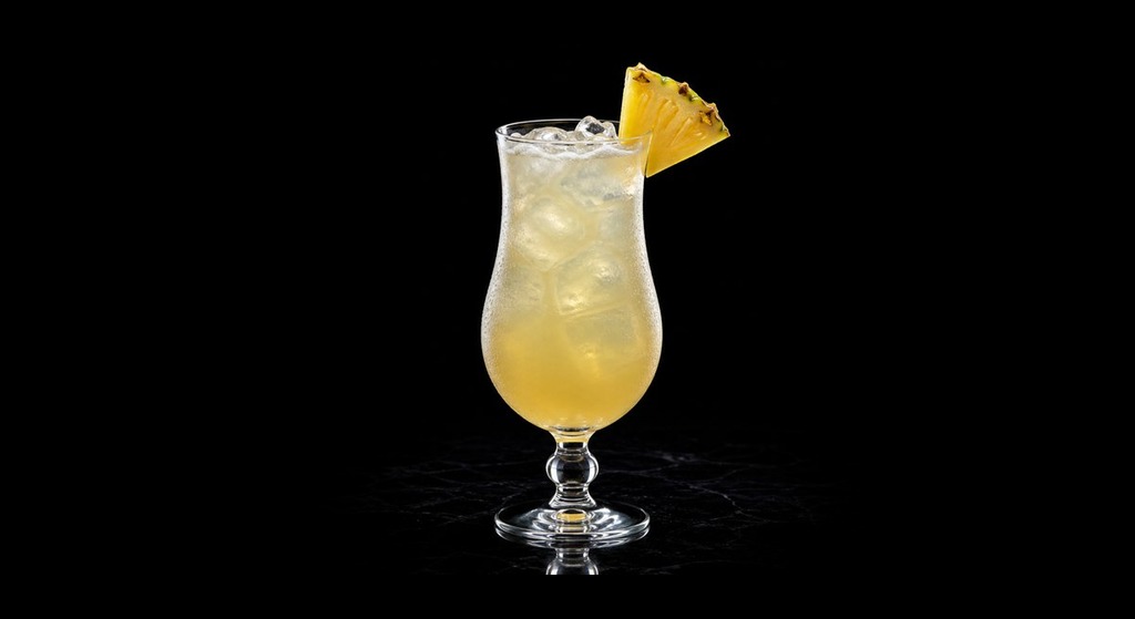 pineapple coconut cooler cocktail on a black studio background