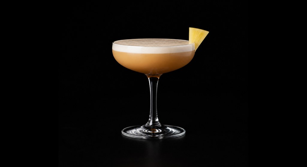 Pineapple Express cocktail on a dark studio background