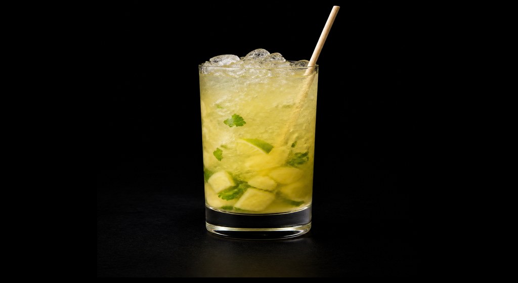 Pineapple & Mint Caipirinha cocktail on a dark studio background