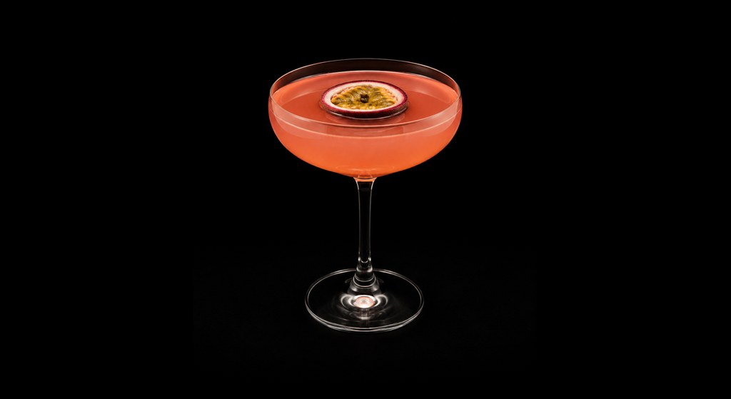 Pink Passion Martini cocktail on a dark studio background