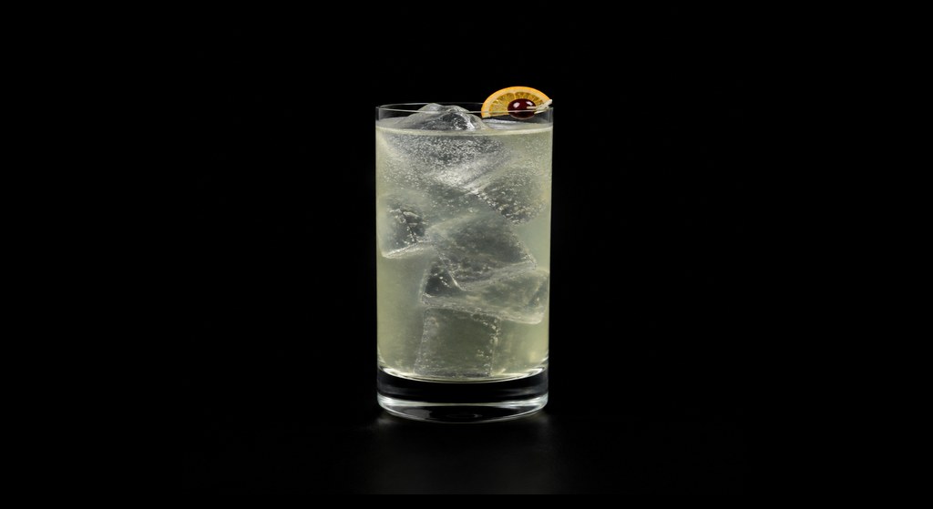 Pisco Collins cocktail on a dark studio background