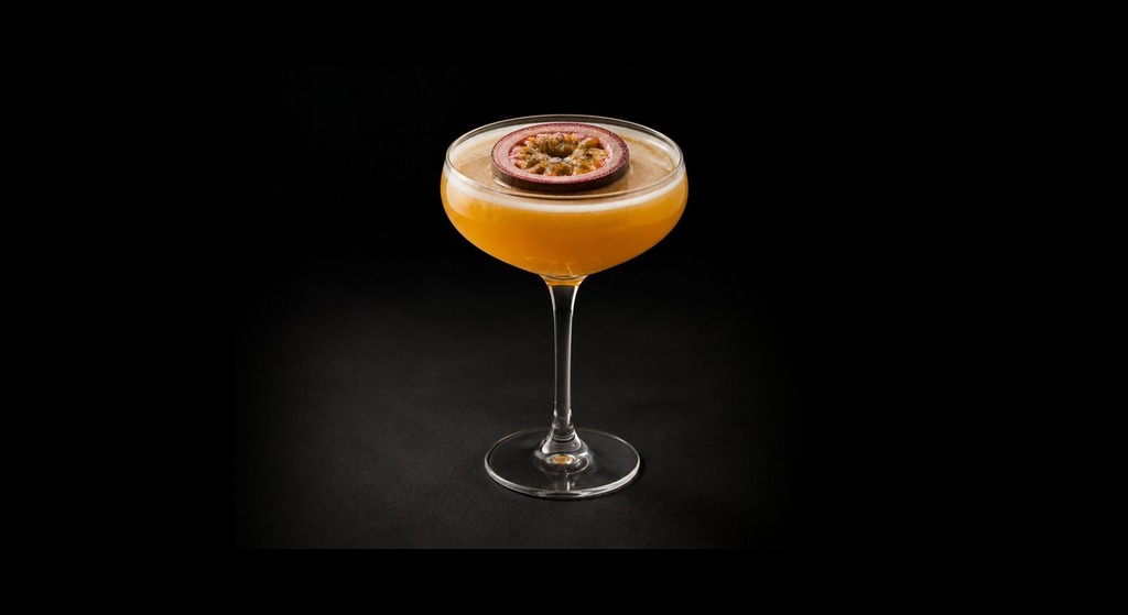 Pornstar Martini cocktail on a dark studio background