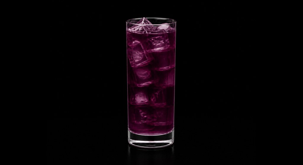 Purple Passion cocktail on a dark studio background