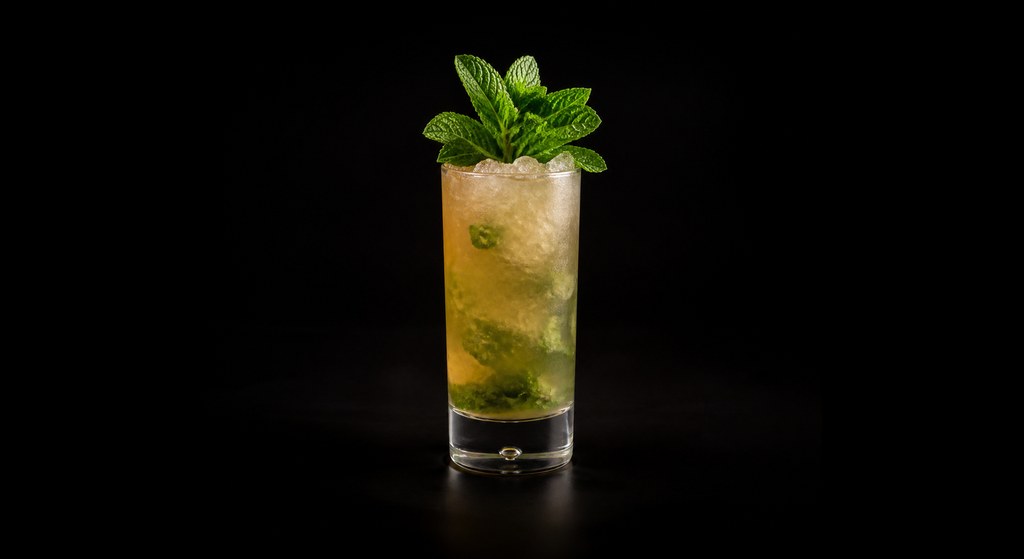 Queen's Park Swizzle cocktail on a dark studio background