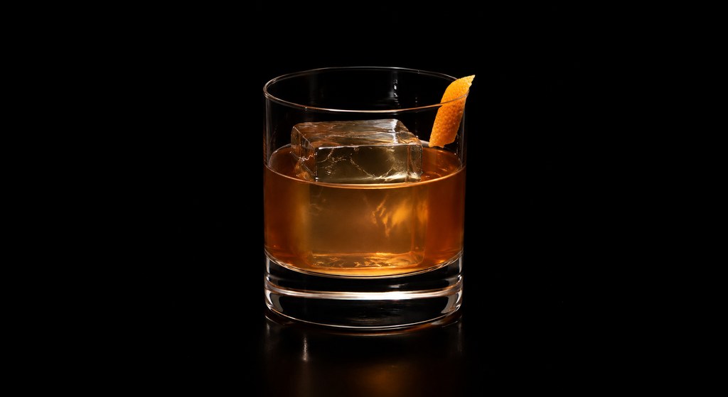 Rum Old Fashioned (Difford's Recipe) cocktail on a dark studio background
