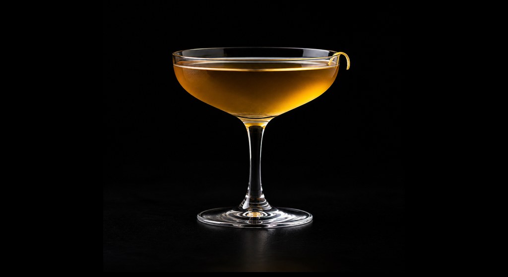 Sainte Trinite (Holy Trinity) cocktail on a dark studio background