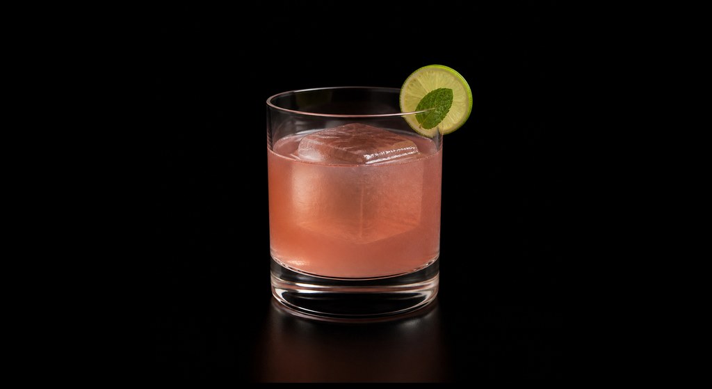 Salted Plum Margarita cocktail on a dark studio background