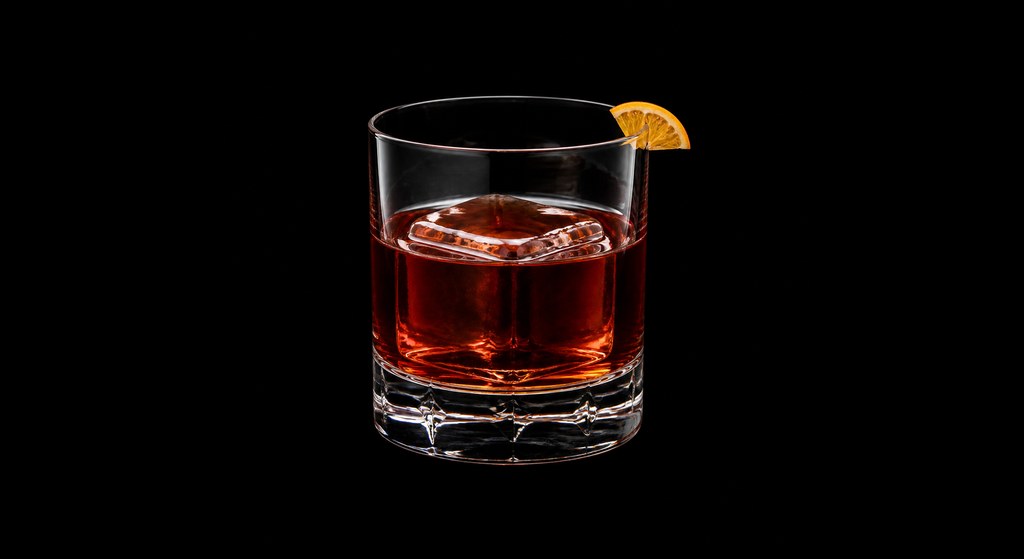 Scotch Negroni cocktail on a dark studio background