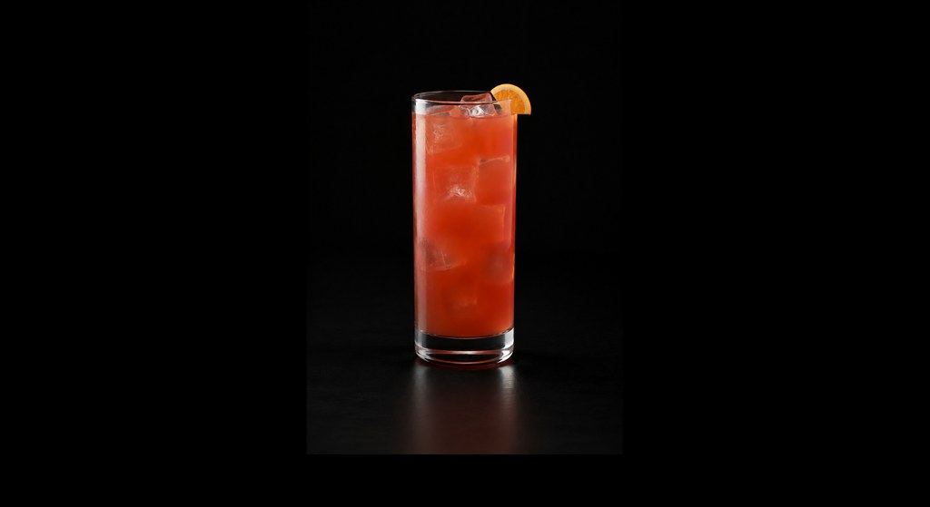 Slow Screw cocktail on a dark studio background