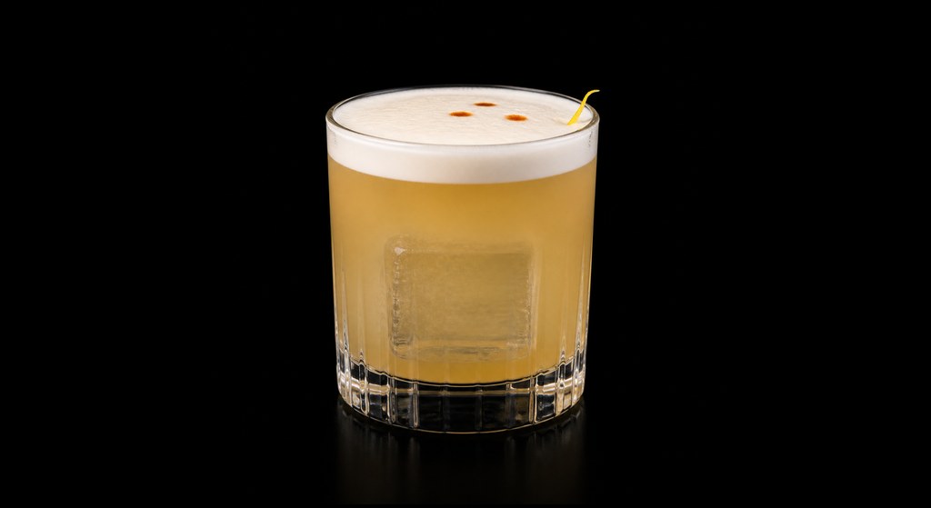 Smoky Whisky Sour cocktail on a dark studio background