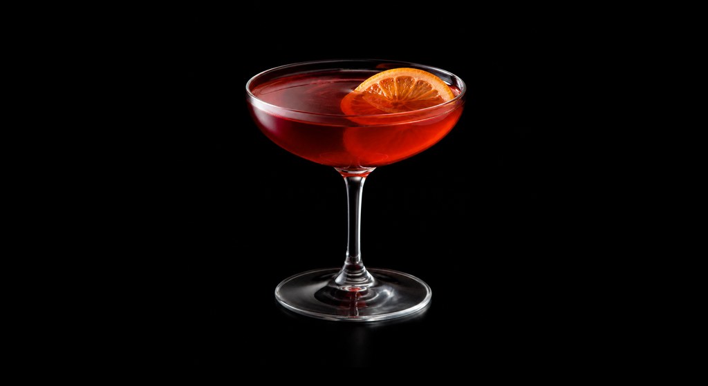 Stanley Tucci's Negroni cocktail on a dark studio background
