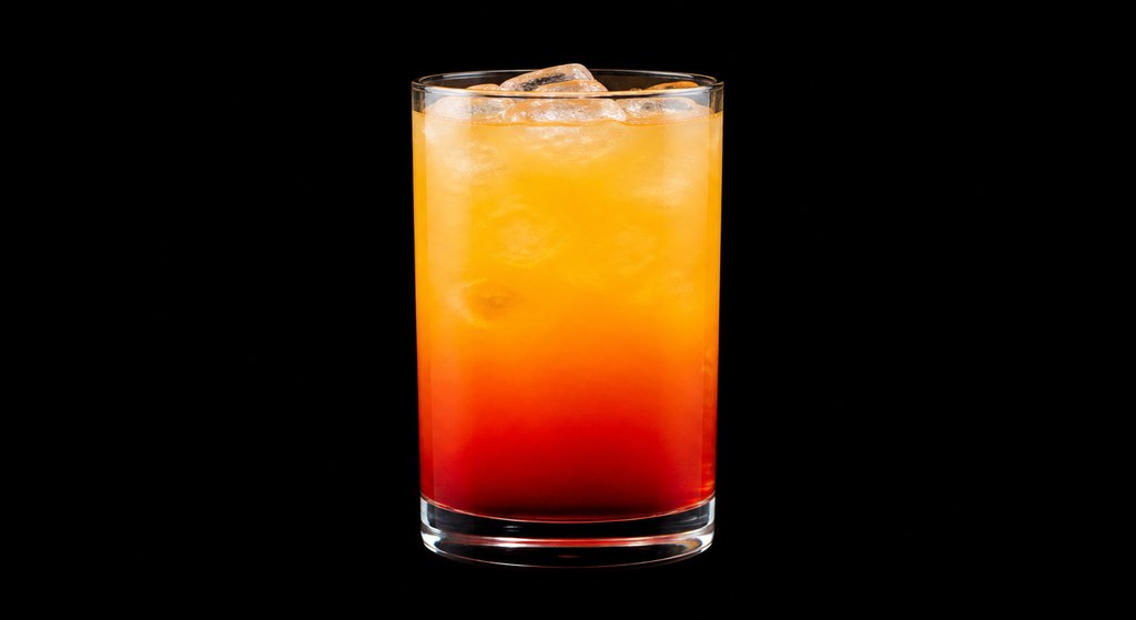 Strawberry Sunrise cocktail on a dark studio background