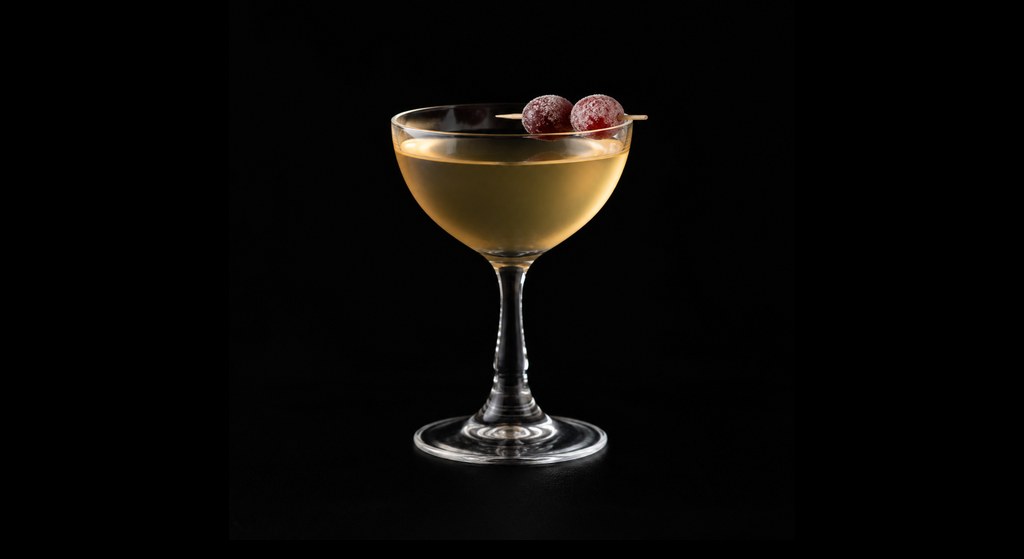 Sugar My Plums cocktail on a dark studio background