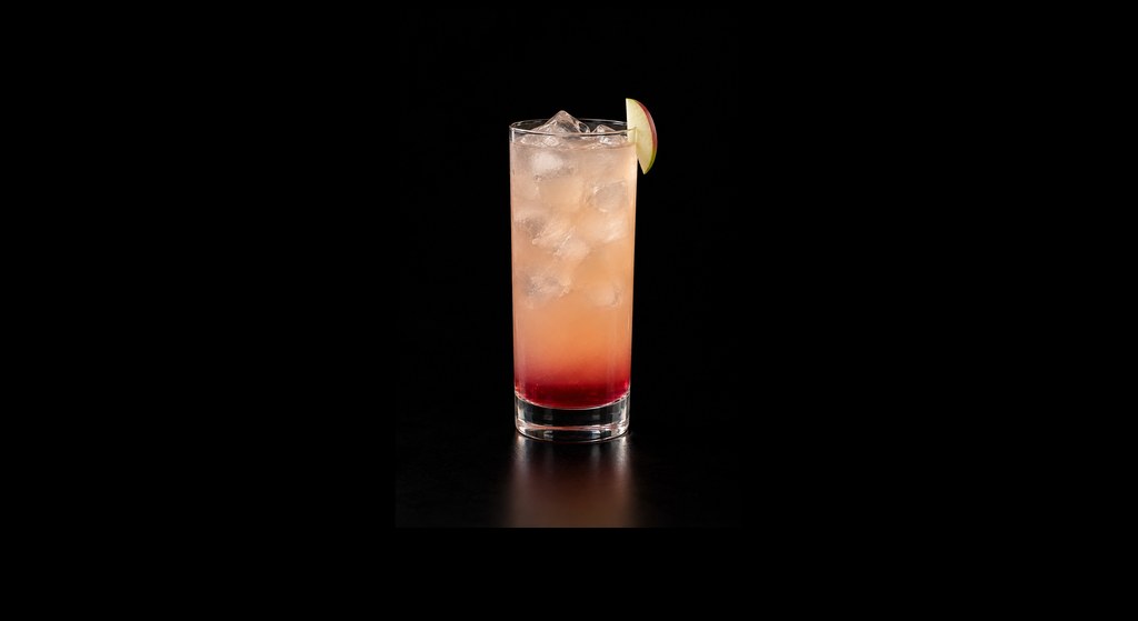 Washington Red Apple cocktail on a dark studio background